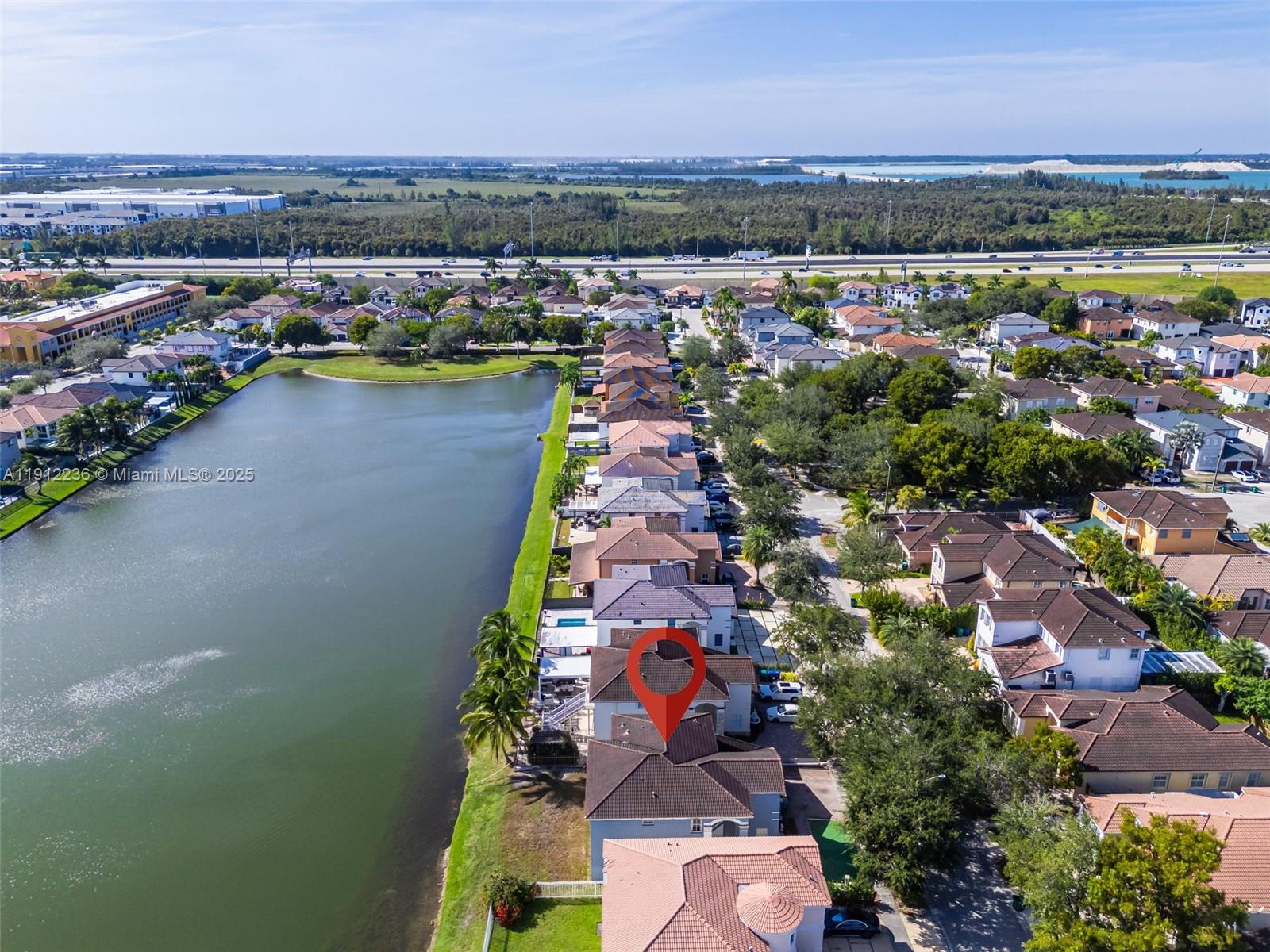 8920 Northwest 180th Terrace Hialeah, FL 33018 - Photo 42 of 44 an aerial view of a city with lots of residential buildings and mountain view in back