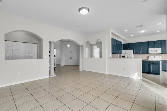 a view of a electric appliances and cabinets in a room
