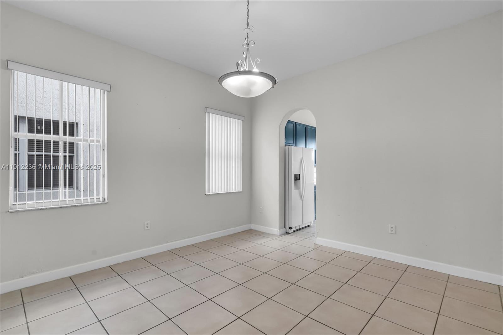 8920 Northwest 180th Terrace Hialeah, FL 33018 - Photo 10 of 44 an empty room with windows and fan