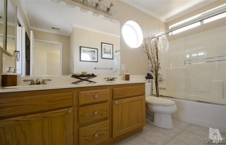 2364 Fitzgerald Road Simi Valley, CA 93065 - Photo 14 of 20 a bathroom with a toilet a sink and mirror