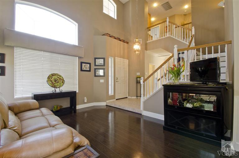 2364 Fitzgerald Road Simi Valley, CA 93065 - Photo 3 of 20 a living room with furniture a flat screen tv and a fireplace