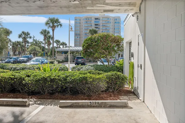 a view of a building with garden and sitting area