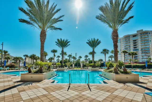 a view of a swimming pool with a house in the background