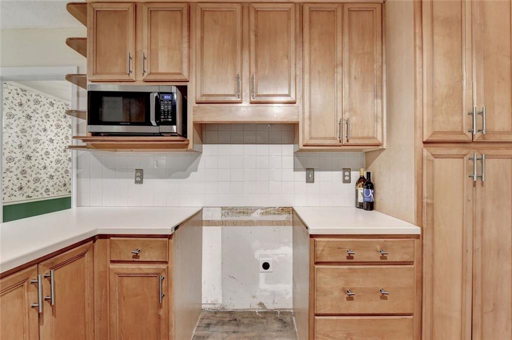 1577 Harbour Oaks Road Tucker, GA 30084 - Photo 21 of 58 a kitchen with granite countertop white cabinets and white appliances