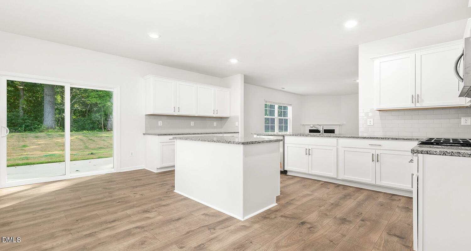 1383 Lansdowne Drive, Unit 401 Mebane, NC 27302 - Photo 11 of 23 a kitchen with white cabinets and white appliances