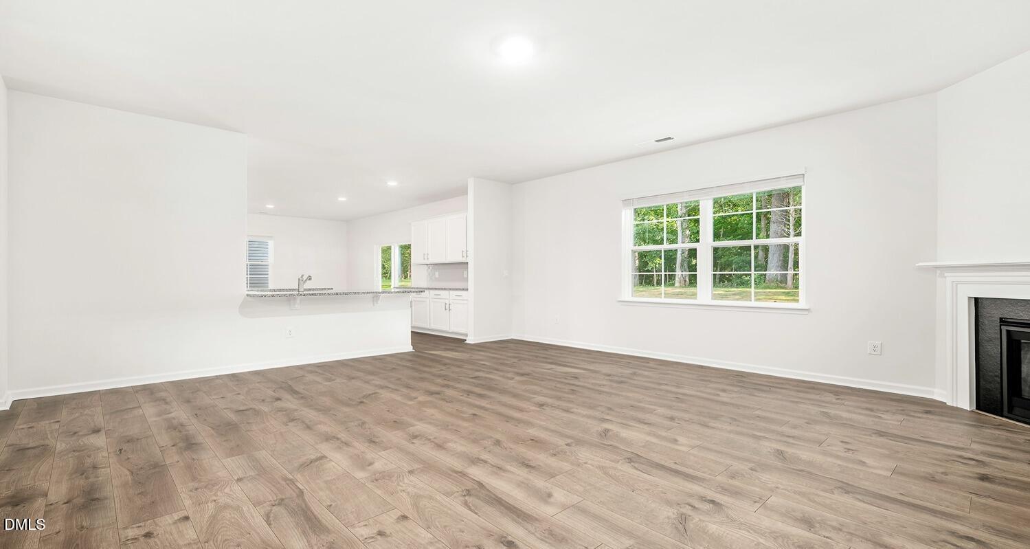 1383 Lansdowne Drive, Unit 401 Mebane, NC 27302 - Photo 7 of 23 an empty room with windows and a fireplace