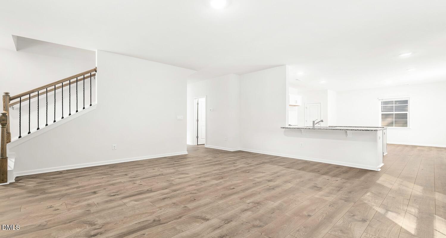 1383 Lansdowne Drive, Unit 401 Mebane, NC 27302 - Photo 8 of 23 a view of an empty room with wooden floor
