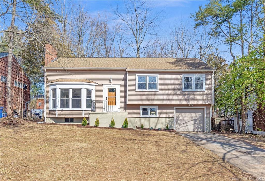 91 Corbin Road Hamden, CT 06517 - Photo 1 of 1 a front view of a house with a yard and garage