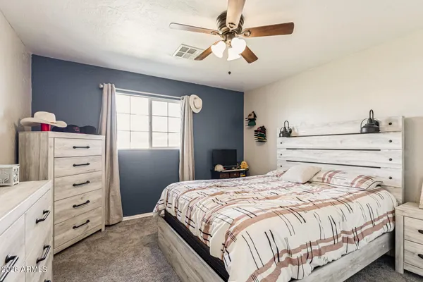 a bedroom with a bed and a dresser