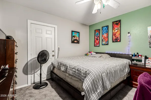 a bedroom with bed and wooden floor
