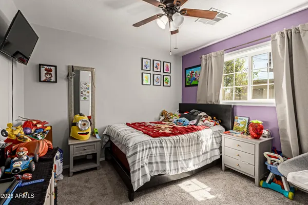 a bedroom with a bed and a chandelier