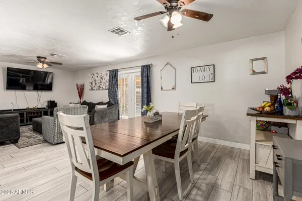 a view of a dining room with furniture and wooden floor