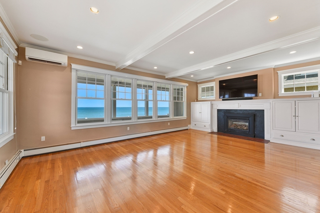 351 Beach Avenue Hull, MA 02045 - Photo 6 of 24 a view of an empty room with a fireplace and a window