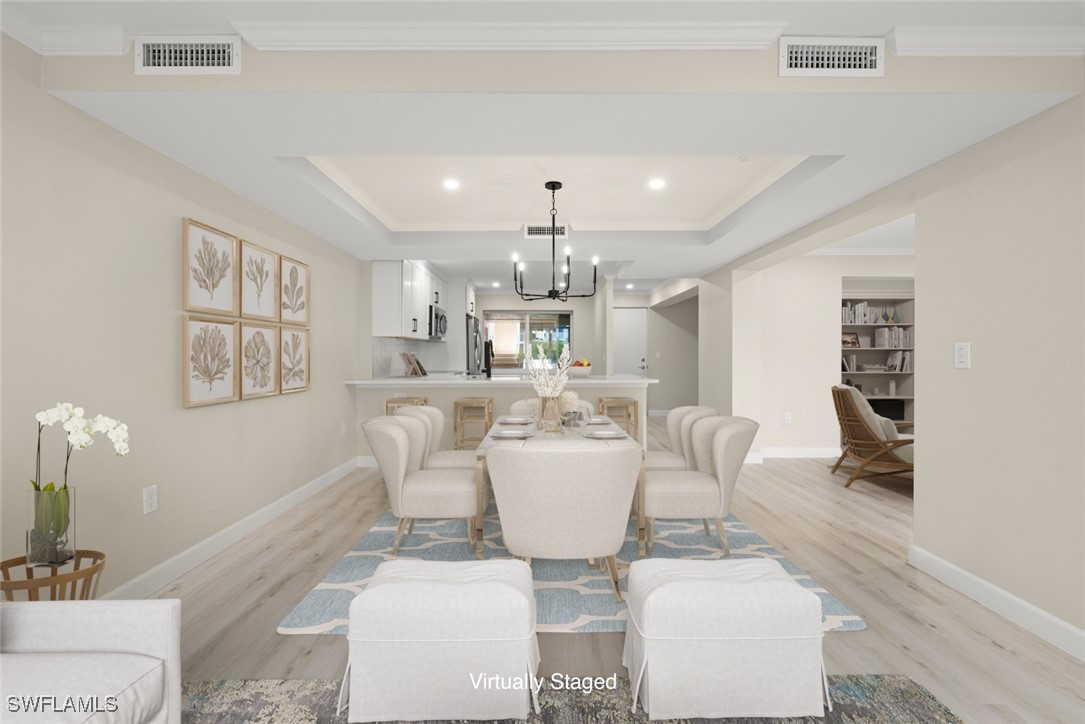 200 Periwinkle Way, Unit 132 Sanibel, FL 33957 - Photo 13 of 44 a view of a dining room with furniture and chandelier