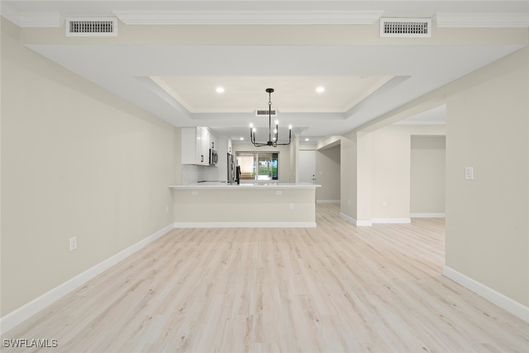 200 Periwinkle Way, Unit 132 Sanibel, FL 33957 - Photo 14 of 44 a view of a kitchen with wooden floor and windows