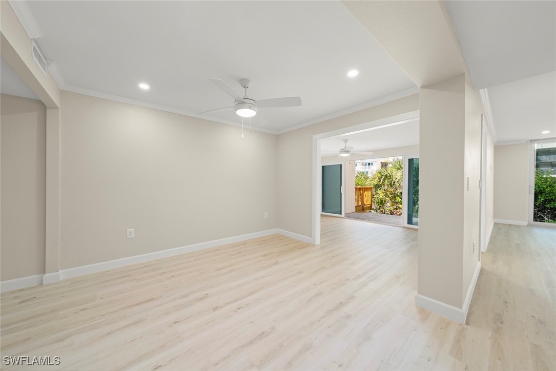 200 Periwinkle Way, Unit 132 Sanibel, FL 33957 - Photo 15 of 44 a view of an empty room with window and wooden floor