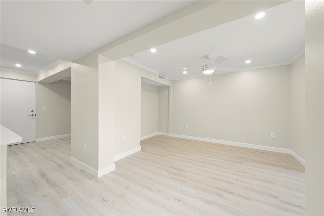 200 Periwinkle Way, Unit 132 Sanibel, FL 33957 - Photo 19 of 44 an empty room with wooden floor and windows