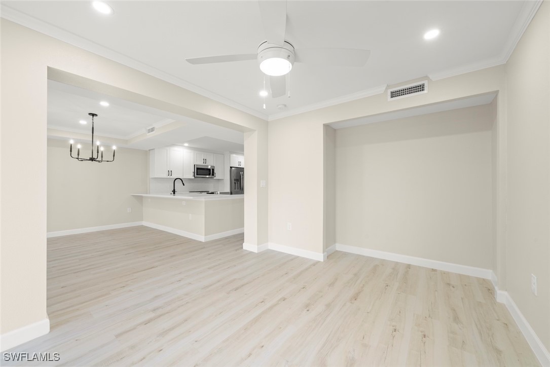 200 Periwinkle Way, Unit 132 Sanibel, FL 33957 - Photo 20 of 44 a view of a kitchen with wooden floor and a sink