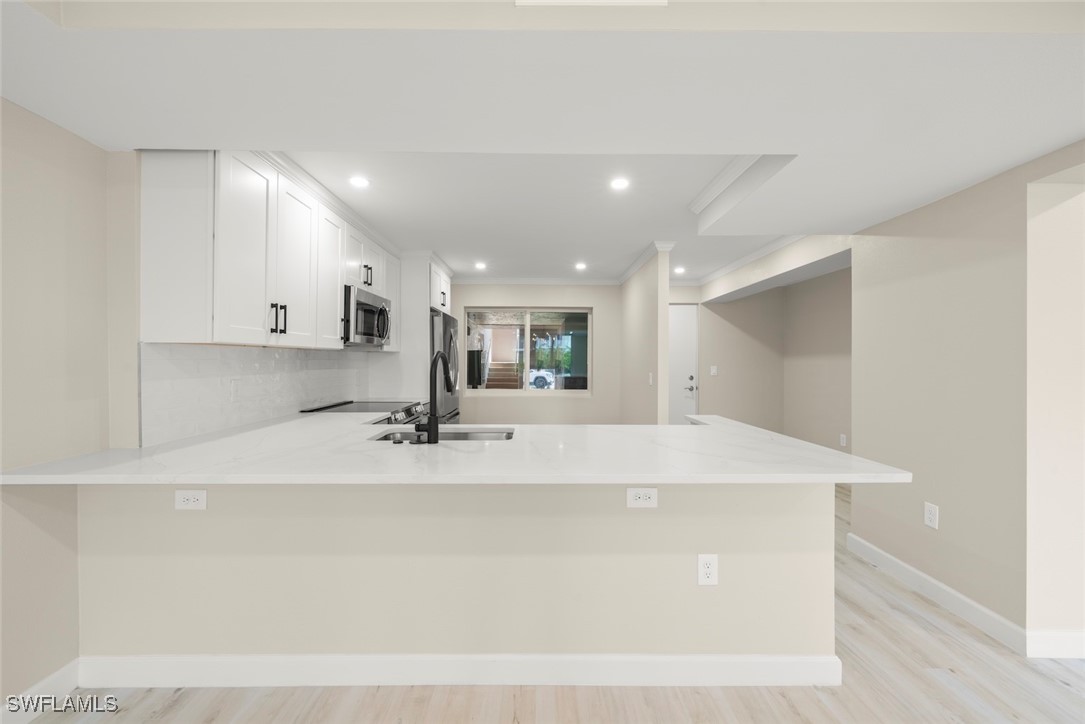 200 Periwinkle Way, Unit 132 Sanibel, FL 33957 - Photo 23 of 44 a view of kitchen with kitchen island