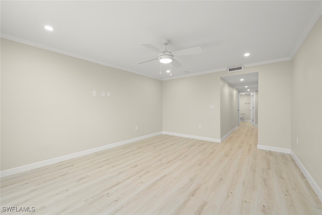 200 Periwinkle Way, Unit 132 Sanibel, FL 33957 - Photo 28 of 44 an empty room with wooden floor and windows