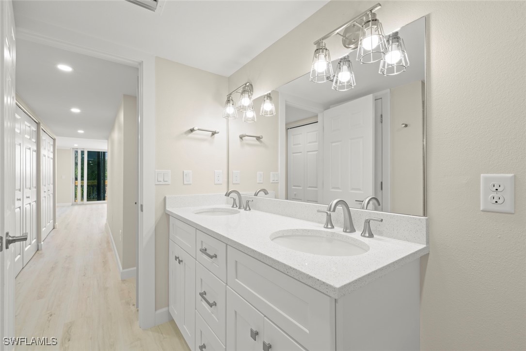 200 Periwinkle Way, Unit 132 Sanibel, FL 33957 - Photo 29 of 44 a bathroom with a sink vanity and a mirror