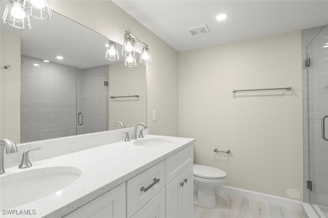 200 Periwinkle Way, Unit 132 Sanibel, FL 33957 - Photo 30 of 44 a bathroom with a toilet a sink and mirror