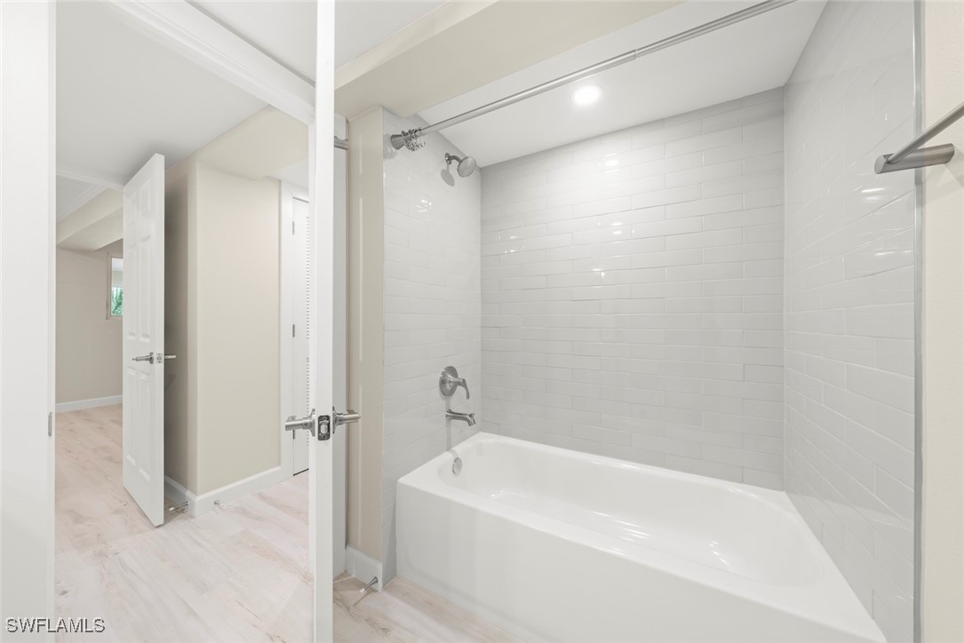 200 Periwinkle Way, Unit 132 Sanibel, FL 33957 - Photo 37 of 44 a white bath tub sitting next to a shower