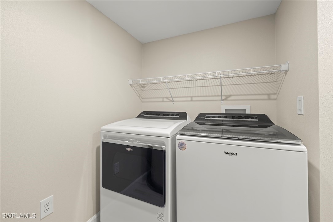 200 Periwinkle Way, Unit 132 Sanibel, FL 33957 - Photo 39 of 44 a utility room with dryer and washer