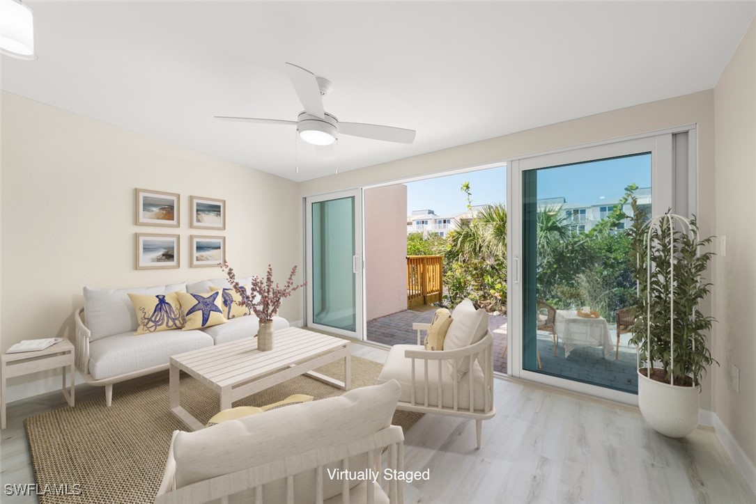 200 Periwinkle Way, Unit 132 Sanibel, FL 33957 - Photo 8 of 44 a living room with furniture and a large window