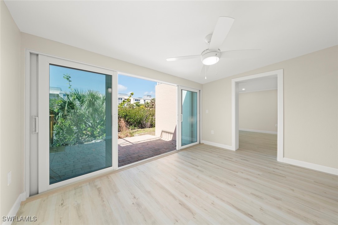 200 Periwinkle Way, Unit 132 Sanibel, FL 33957 - Photo 10 of 44 a view of an empty room with wooden floor and a window