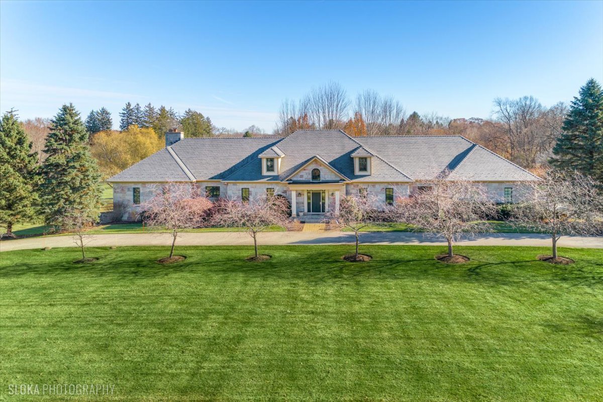 a house with swimming pool in front of it