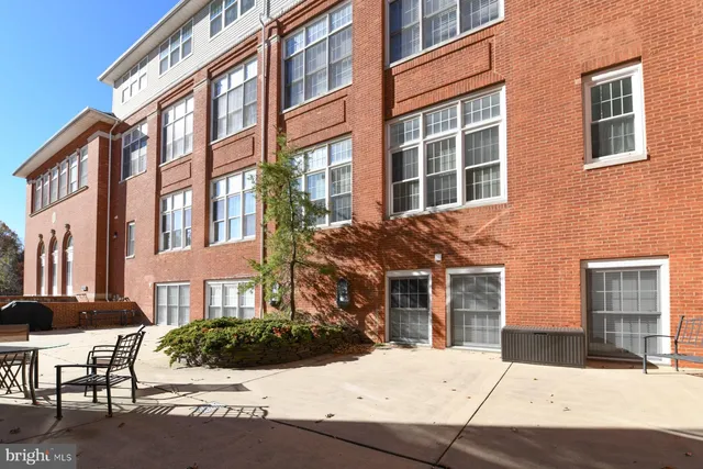 a aerial view of a house with a yard wooden table and chairs