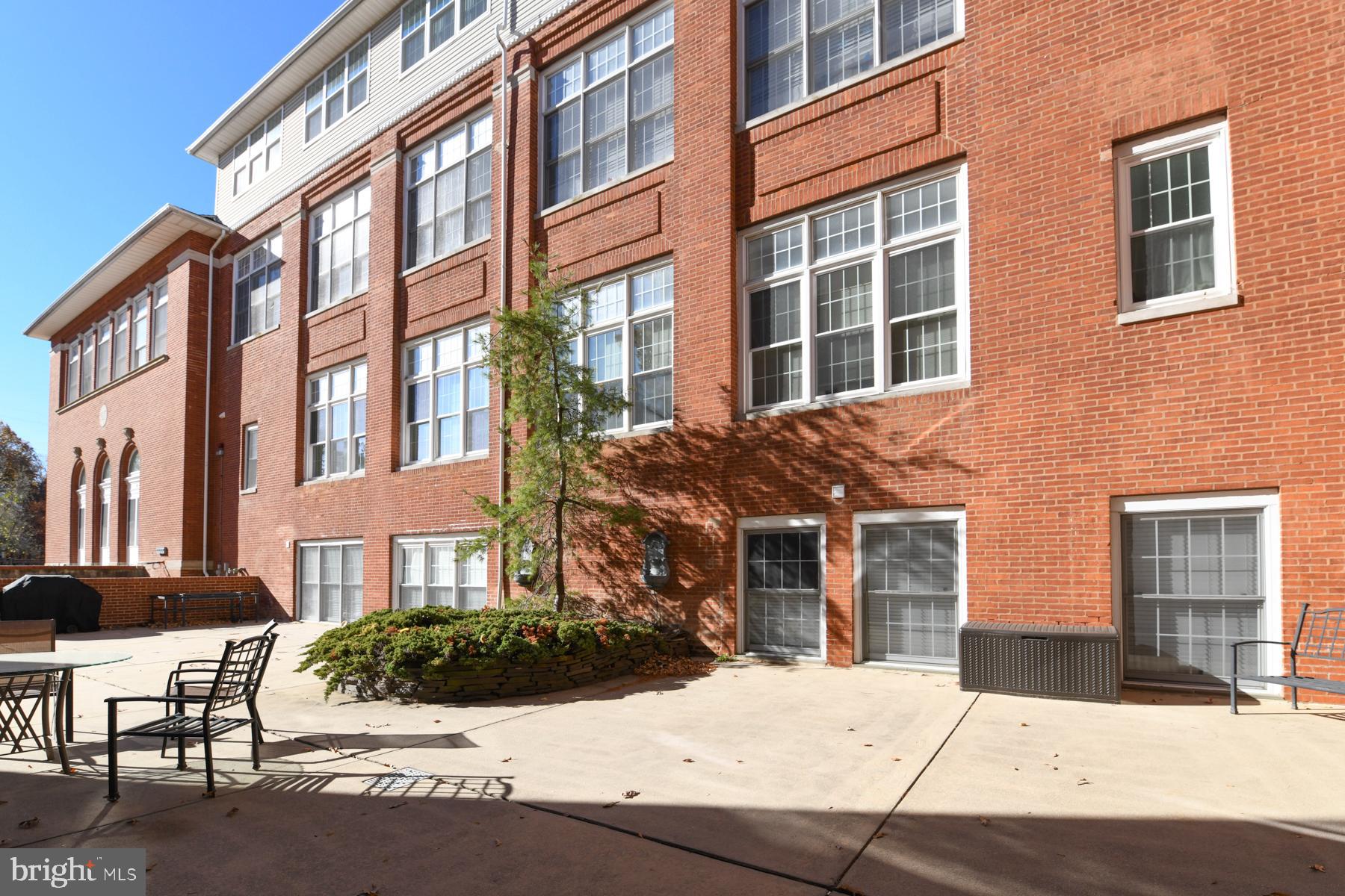 100 Aura Road, Unit 111 Clayton, NJ 08312 - Photo 11 of 34 a view of a building next to a yard