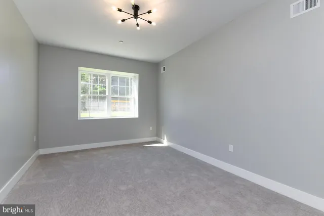 a bathroom with a bathtub sink vanity and mirror