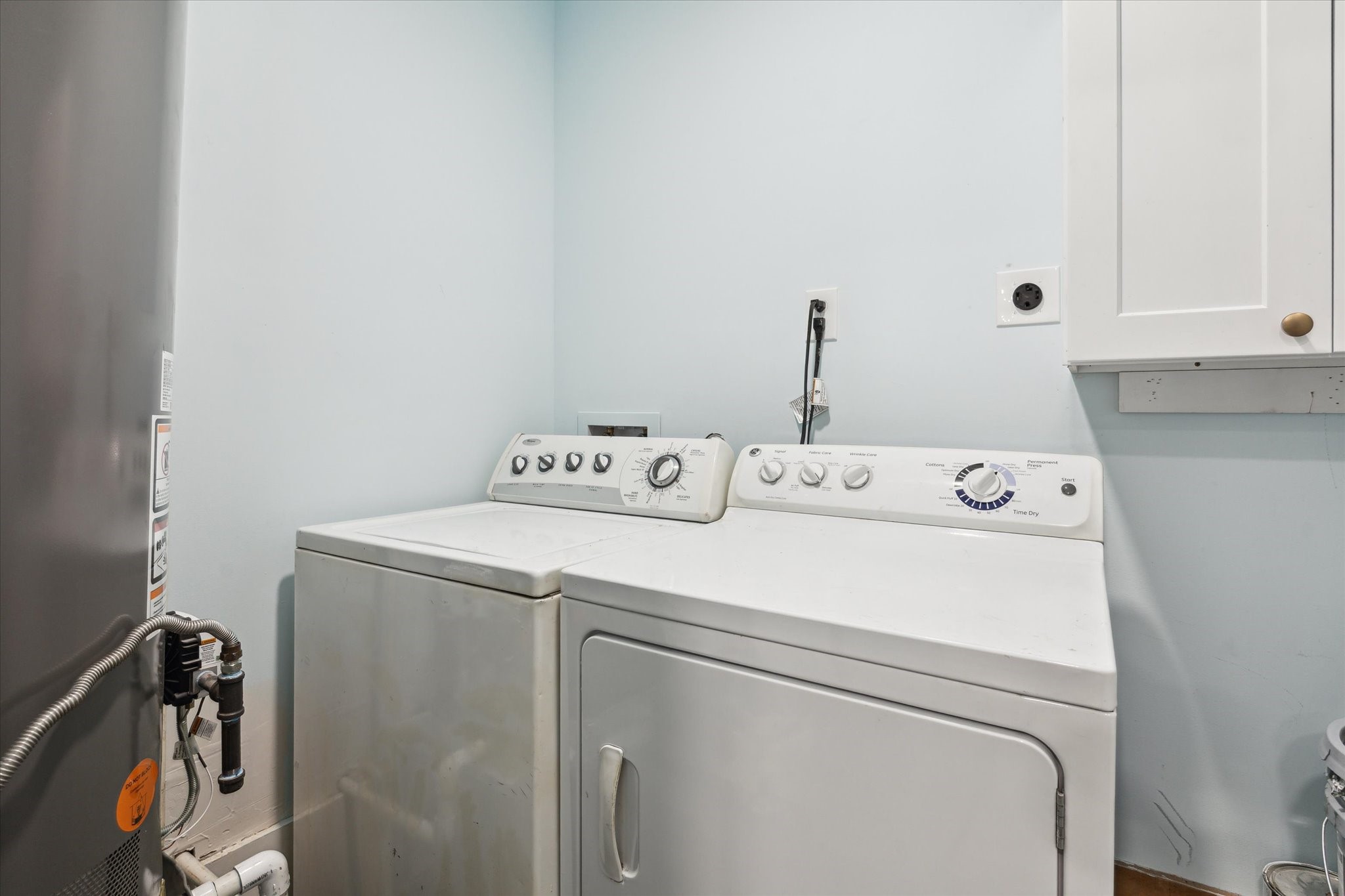 522 Barkley Street Houston, TX 77022 - Photo 15 of 18 Laundry room with full size washer and dryer, storage cabinets.
