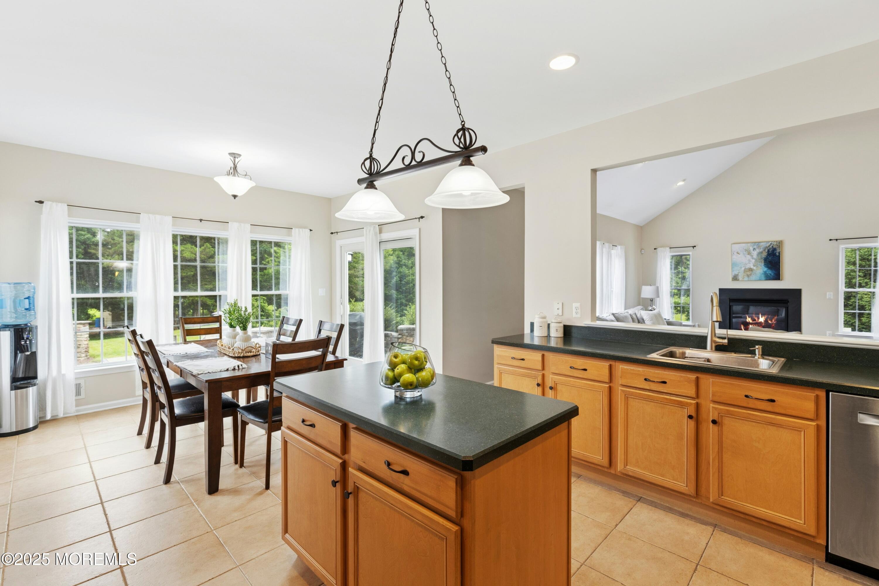 7 Topaz Drive Jackson, NJ 08527 - Photo 9 of 51 a kitchen with a stove a sink a dining table and chairs with wooden floor