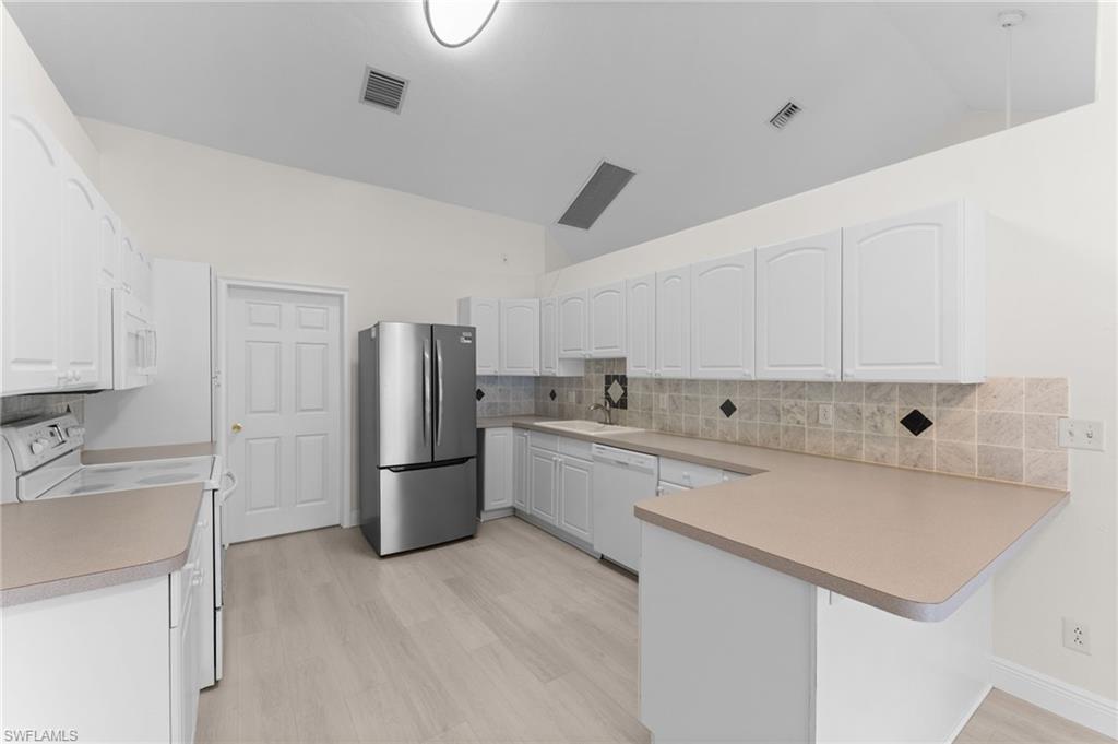 17568 Braddock Road Fort Myers, FL 33967 - Photo 8 of 29 a kitchen with a sink and refrigerator