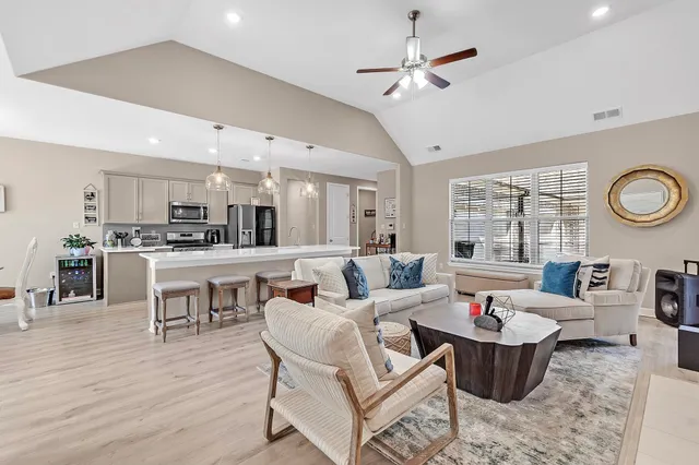 a living room with furniture and kitchen view