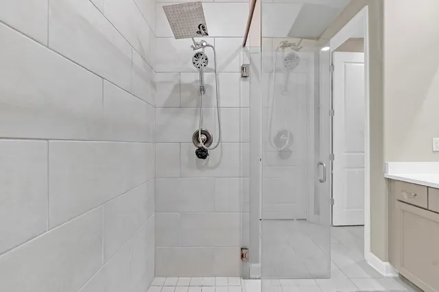 a spacious bathroom with a shower and a sink