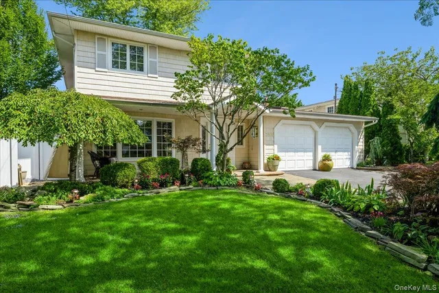 a front view of a house with a garden and porch