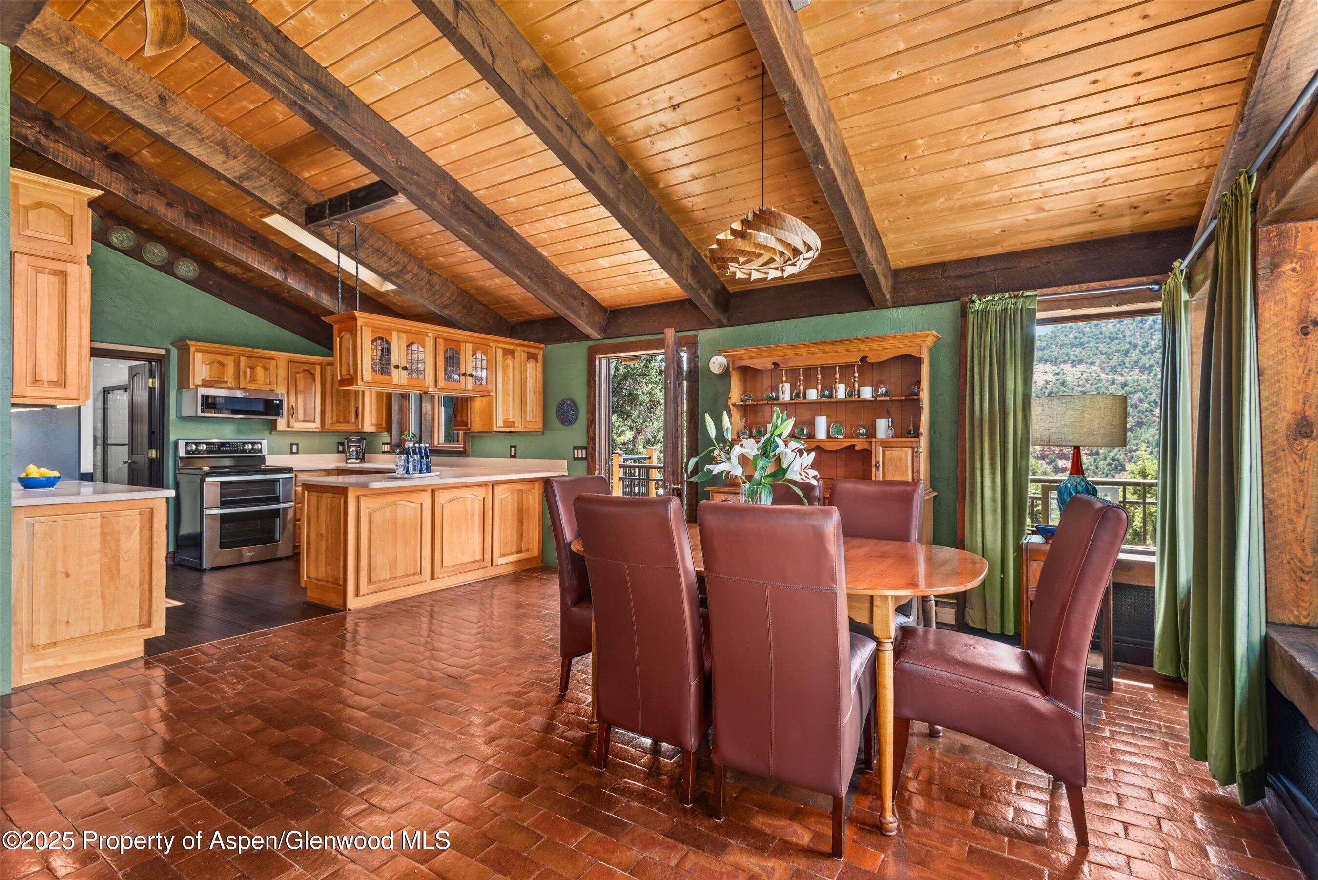 679 Pinon Drive Basalt, CO 81621 - Photo 20 of 52 a dining room with furniture a kitchen view and large windows