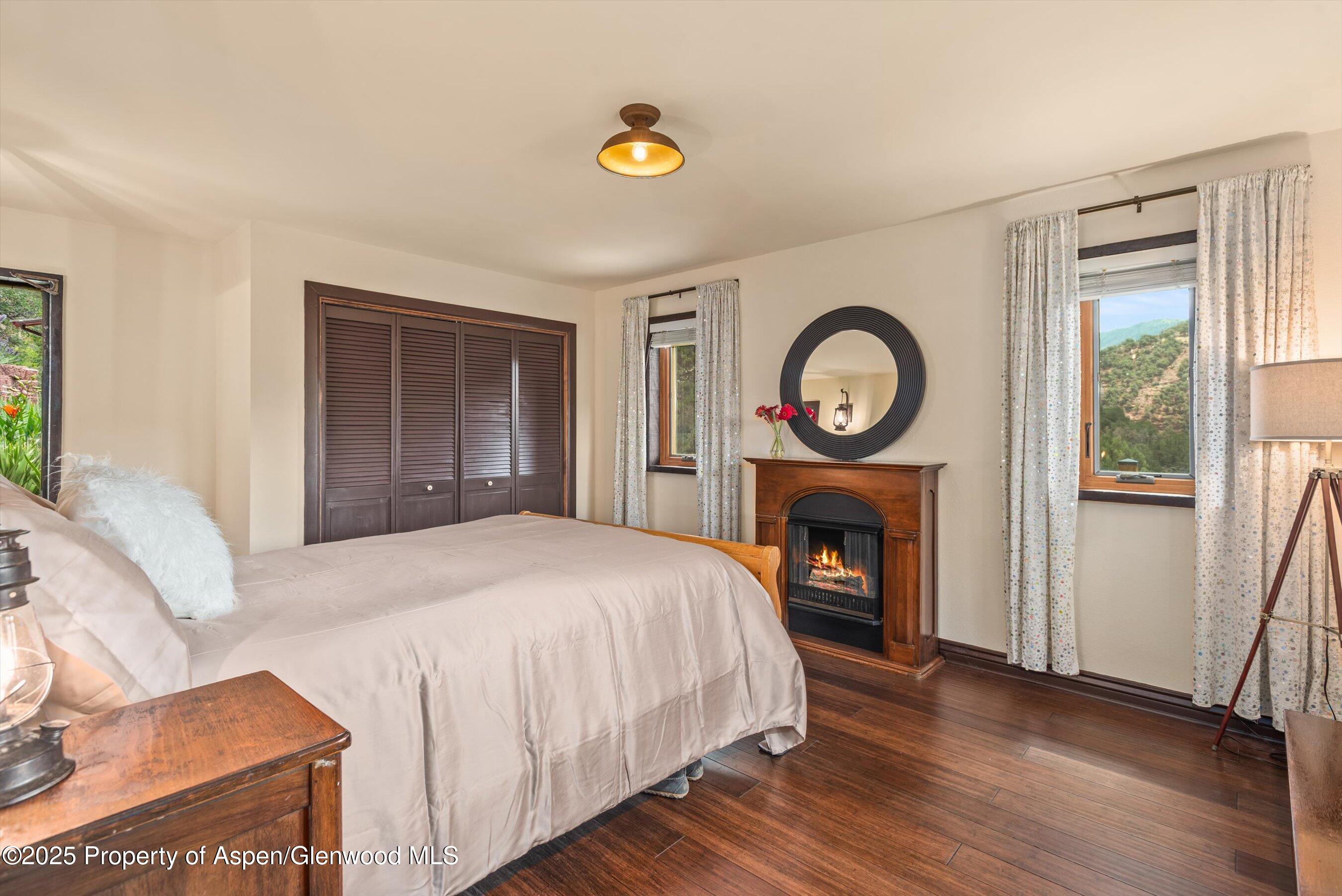 679 Pinon Drive Basalt, CO 81621 - Photo 29 of 52 a bed sitting in a spacious bedroom next to a window and a mirror