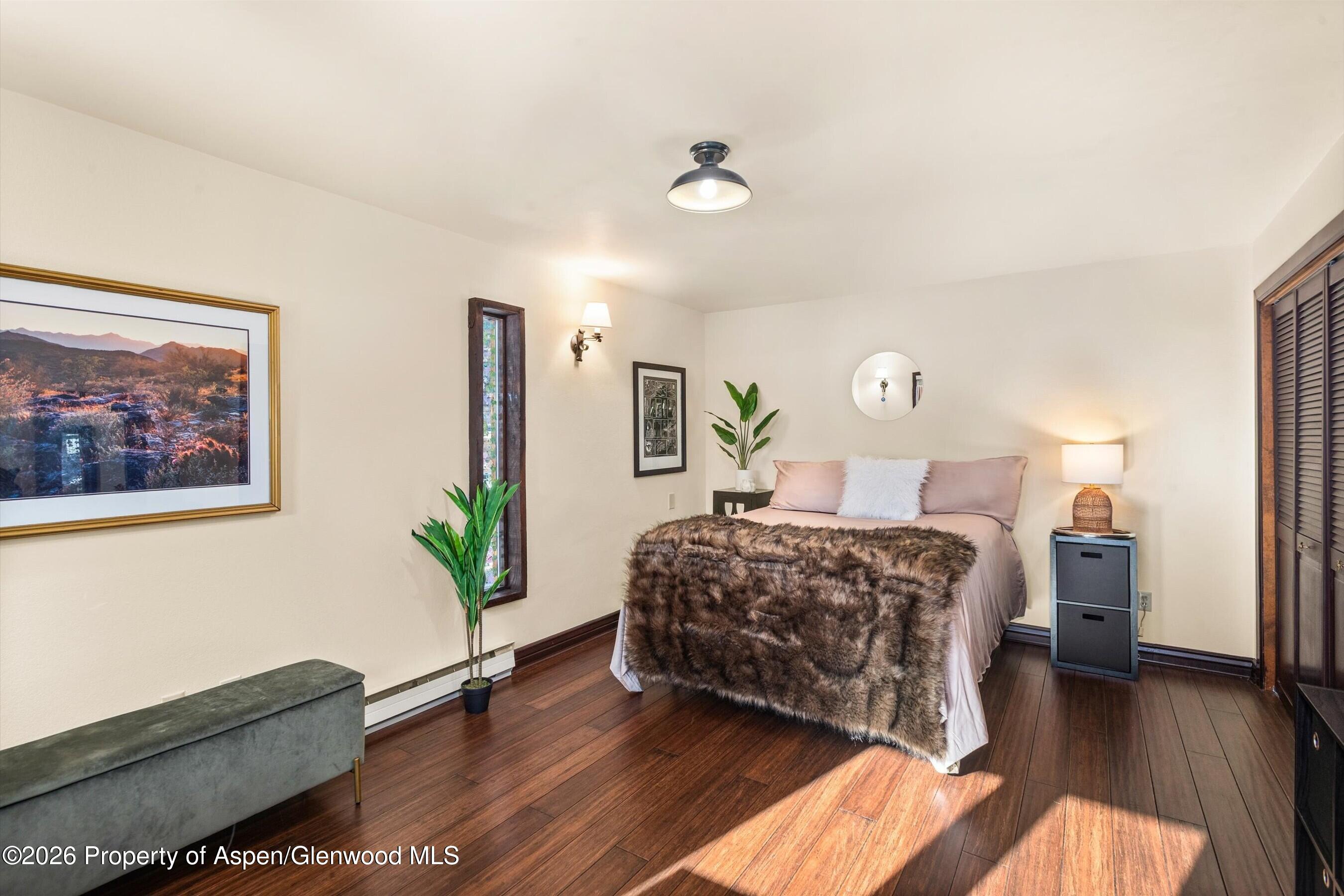 679 Pinon Drive Basalt, CO 81621 - Photo 32 of 52 a bedroom with a bed couch and a potted plant