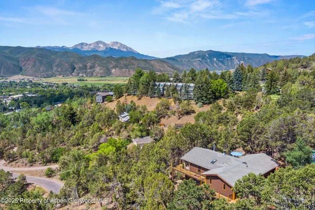 an aerial view of a house with a yard