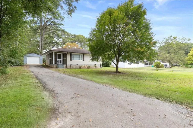 a view of house with yard and green space