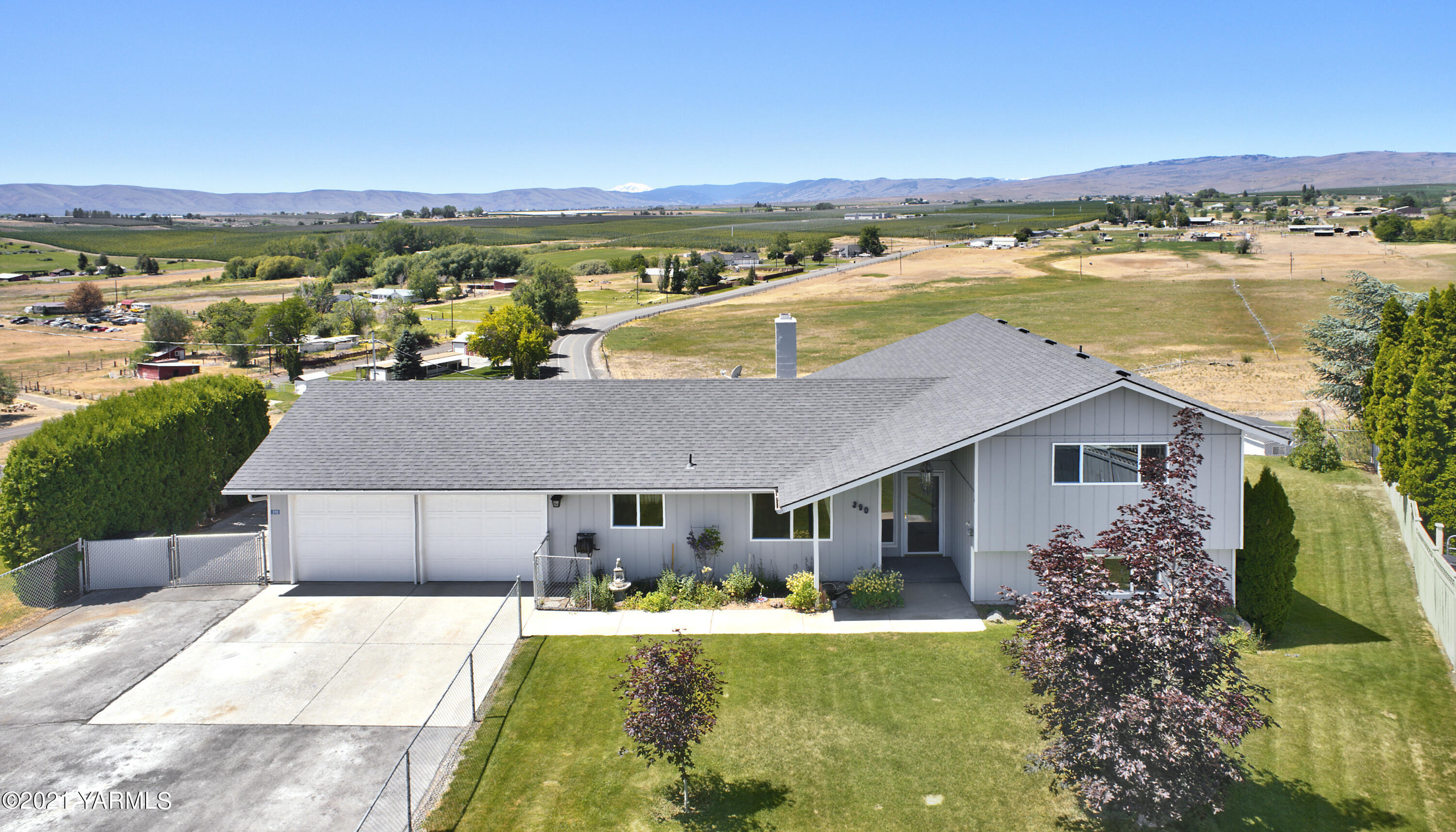 390 Mahre Road Yakima, WA 98908 - Photo 1 of 21 a aerial view of a house with a garden and lake view