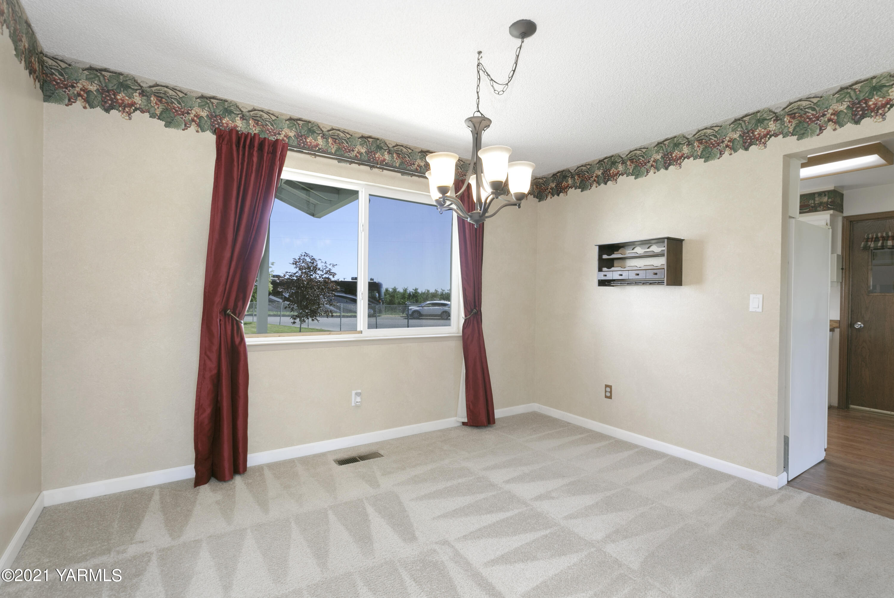 390 Mahre Road Yakima, WA 98908 - Photo 8 of 21 a view of a livingroom with a chandelier fan and windows