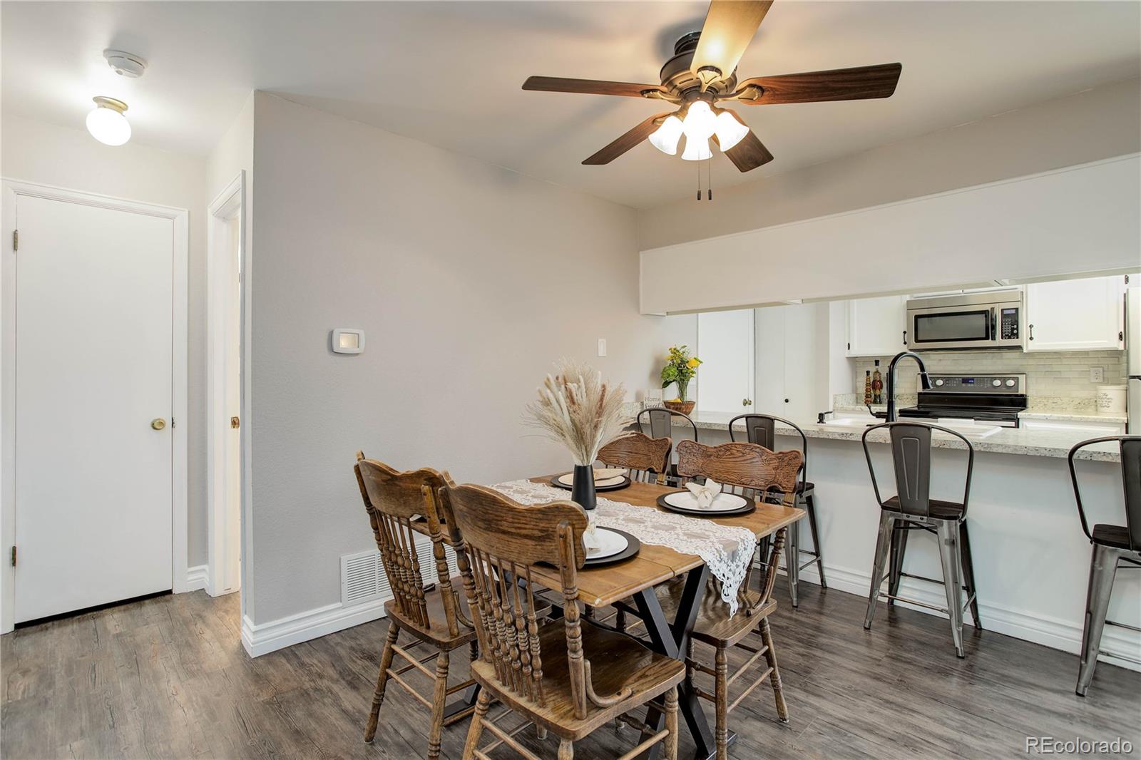 9413 West 89th Circle Westminster, CO 80021 - Photo 11 of 32 a view of a dining room with furniture and wooden floor