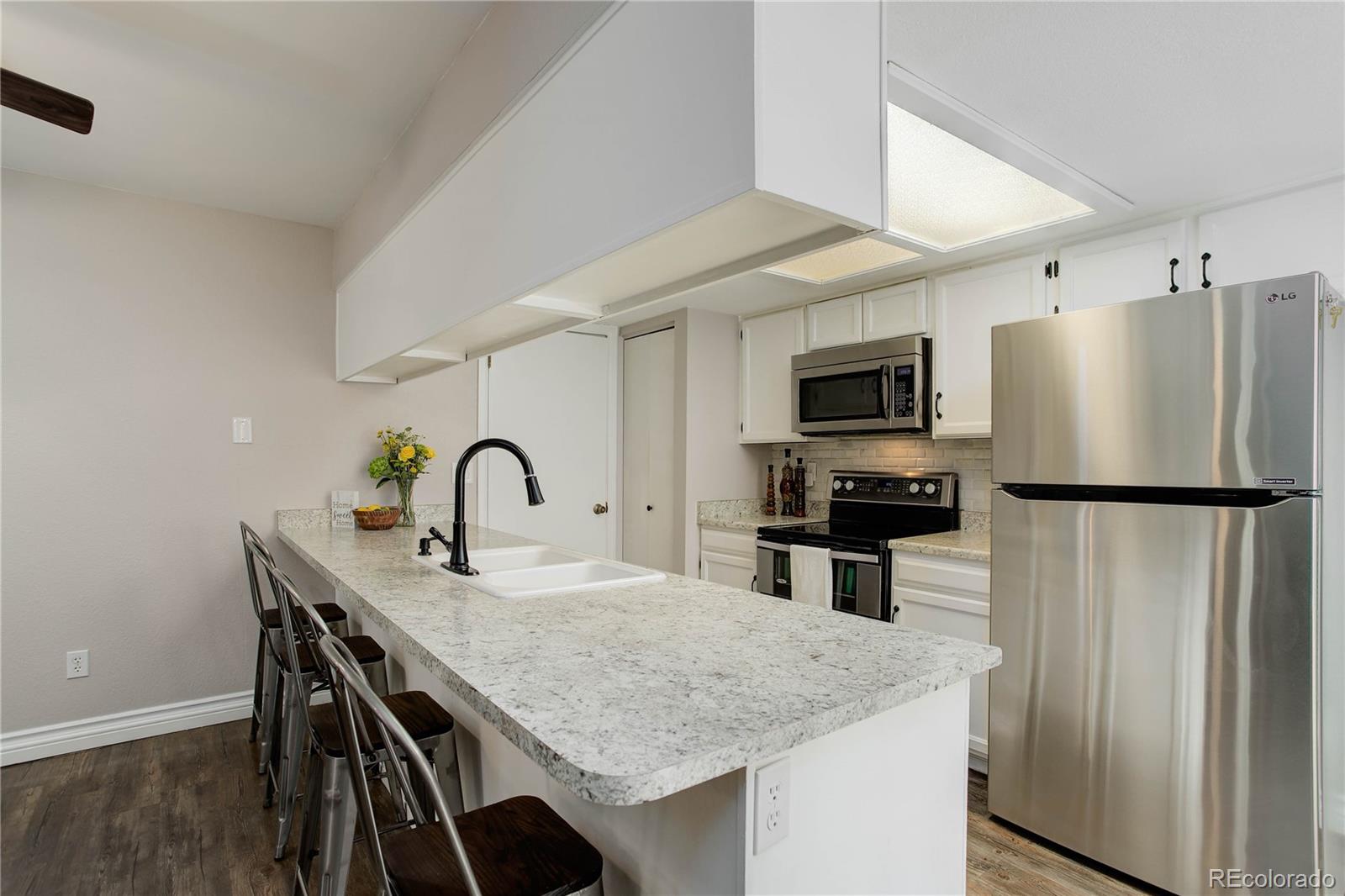 9413 West 89th Circle Westminster, CO 80021 - Photo 15 of 32 a kitchen with stainless steel appliances granite countertop a refrigerator a stove a sink and a refrigerator