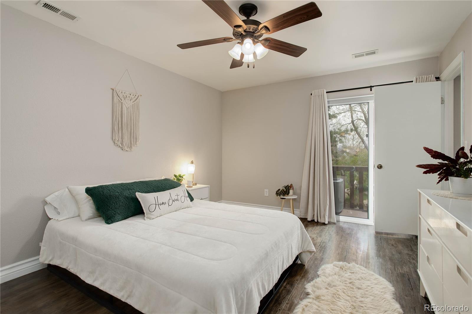 9413 West 89th Circle Westminster, CO 80021 - Photo 16 of 32 a bedroom with a bed and a chandelier